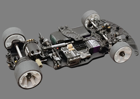 Atomic RC MRX Master Edition Linkless 2WD chassis with detailed components and black finish, designed for high-performance remote control cars.