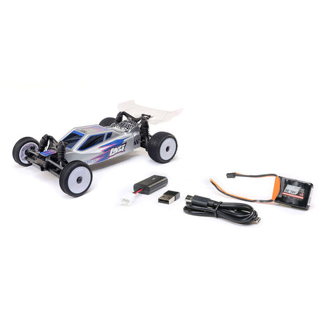 Losi Micro-B 2WD 1/24 scale RC buggy with black and red body and large tires, designed for off-road racing and stunt driving.