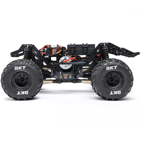 Losi 1/18 Mini LMT Zombie 2S 4X4 brushed monster truck on rugged terrain, showcasing its compact off-road design and detailed body.
