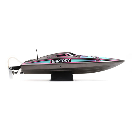 Proboat Heatwave Recoil 2 V2 26-inch self-righting RC boat on water, showcasing sleek design and vibrant color scheme.