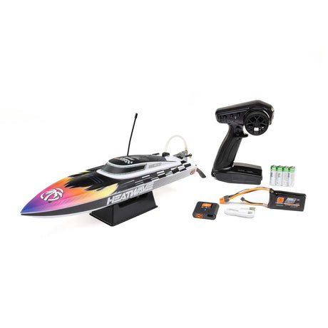Proboat Recoil 2 18-inch self-righting brushless deep-V RC boat on water, showcasing its sleek design and bright color scheme.