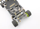 Reflex Racing RX28A-01 RC car rear brass and carbon fiber lower pod plate showing detailed metal and carbon fiber components.