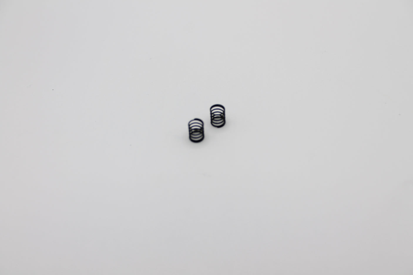 Reflex Racing RX28A-10 medium soft front springs for RC car, black color, designed for optimal handling and performance.