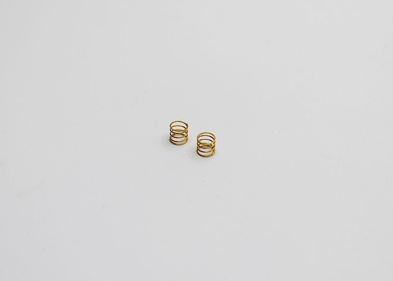 Reflex Racing RX28A-17-MS Medium Kiss Front Springs V2 for RC car, gold-colored suspension springs in close-up view.