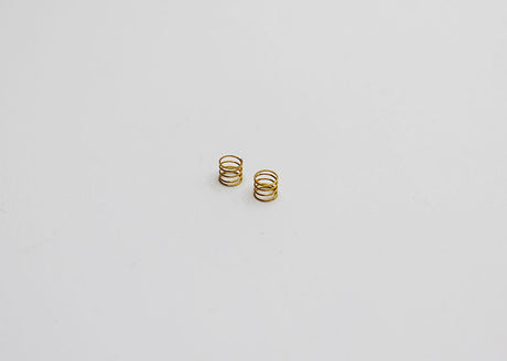 Reflex Racing RX28A-17-MS Medium Kiss Front Springs V2 for RC car, gold-colored suspension springs in close-up view.