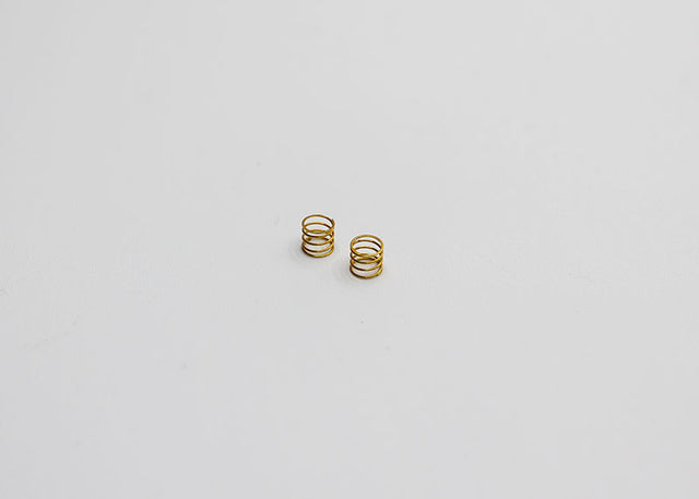 Reflex Racing RX28A-17-MS Medium Kiss Front Springs V2 for RC car, gold-colored suspension springs in close-up view.