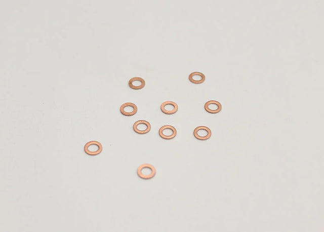 Reflex Racing RX501 M3x0.5mm rear axle shims for RC cars, set of 10, small metal spacers for precise wheel fitment.