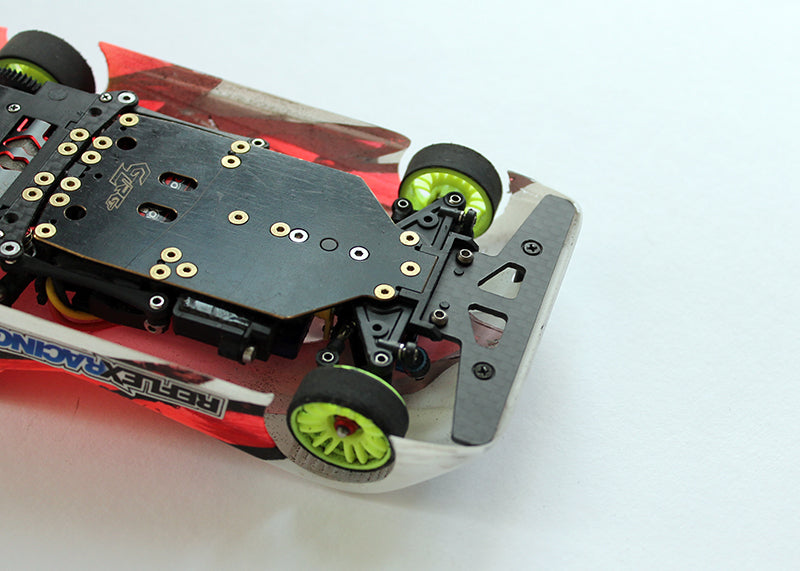 Reflex Racing RX503 RC car carbon fiber front bumper, lightweight and durable for racing performance, shown on a blue background.