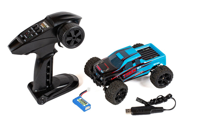 Rage RC Mini Trek MT 1/24 scale remote control monster truck on a dirt track, showcasing rugged design and off-road tires.