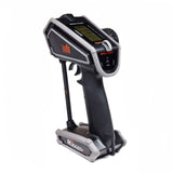 Spektrum DX Rugged+ 12-channel DSMR transmitter with SR615 receiver, shown with controls and display in a close-up view.