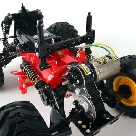 Tamiya 1/10 Blackfoot 2WD Monster Truck Kit model with detailed orange and black body and rugged off-road tires.