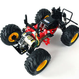 Tamiya 1/10 Blackfoot 2WD Monster Truck Kit model with black and orange body, large tires, and detailed chassis components.