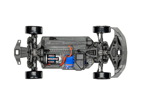 Traxxas 4-Tec Drift Ford Mustang remote control car on a racing track, showcasing its detailed black and white design.