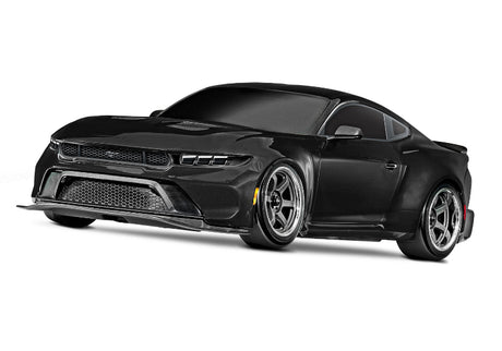 Black Traxxas 4-Tec Drift Ford Mustang radio-controlled car on a smooth surface.