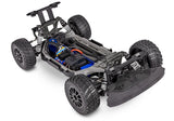 Traxxas Ford Fiesta ST Rally VXL RC car with detailed exterior, rally decals, and off-road tires on rugged terrain.