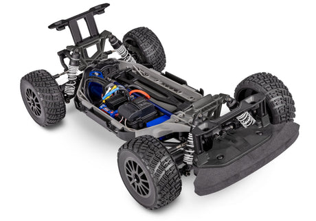 Traxxas Ford Fiesta ST Rally VXL RC car with detailed exterior, rally decals, and off-road tires on rugged terrain.