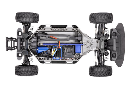 Traxxas Ford Fiesta ST Rally VXL radio-controlled car on a track, detailed orange and black body with Rally design.