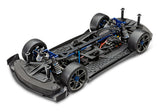 Traxxas XO-1 AWD supercar with sleek black body, aerodynamic design, and detailed wheels on a race track.