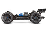 Orange Traxxas XRT 8S radio-controlled monster truck with large tires and detailed body in a dynamic outdoor setting.
