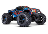 Traxxas X-Maxx 8s belted monster truck with large tires and detailed body, shown on rugged terrain.