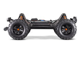Traxxas X-Maxx 8S belted monster truck with large tires and rugged design on off-road terrain.
