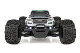 Team Associated Reflex 14MT 1/14 scale 4WD RC monster truck with detailed body and rugged tires on rugged terrain.