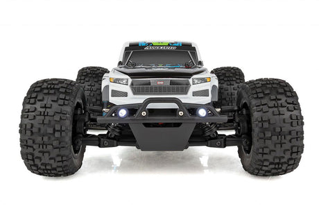 Team Associated Reflex 14MT 1/14 scale 4WD RC monster truck with detailed body and rugged tires on rugged terrain.