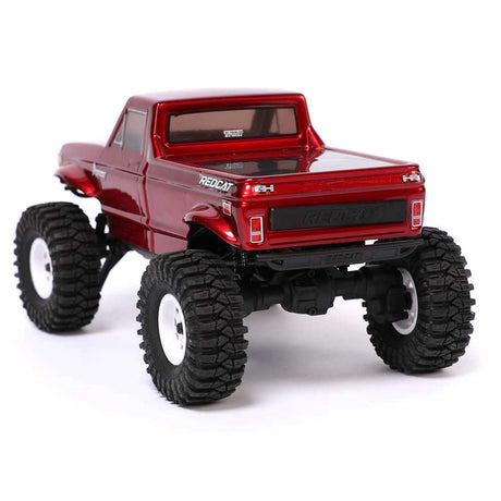 Redcat Ascent-18 off-road RC crawler with red body and rugged tires, ready for outdoor adventures.