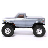 Redcat Ascent-18 RC off-road vehicle with gray body and rugged tires, designed for durability and performance on rough terrain.