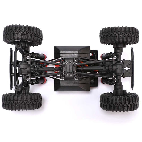 Redcat Ascent-18 RC off-road truck chassis with red and black components, showcasing the detailed frame and suspension system.