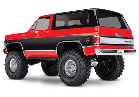 Red Traxxas TRX-4 1979 Chevrolet Blazer RC vehicle shown from a rear three-quarter angle.