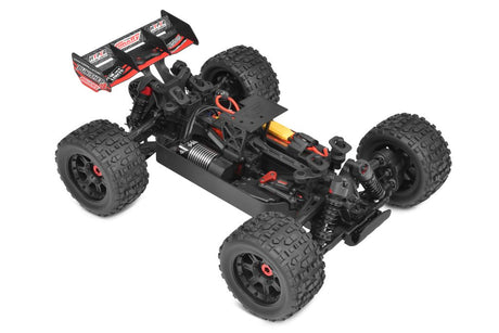 Team Corally Punisher 4S RTR monster truck in red with large off-road tires and rugged suspension, ready for outdoor racing.