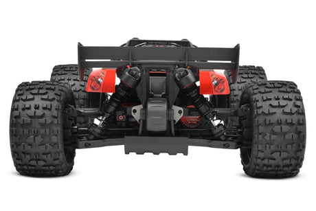 Team Corally Punisher 4S RTR monster truck with large tires and rugged design, shown on a dirt surface for off-road racing.