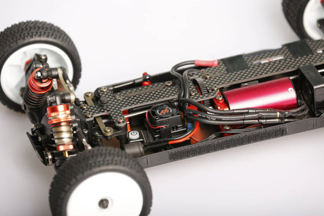 LC Racing LC12B1-HK 1/12 4WD competition buggy kit with motor and ESC, showing the assembled radio-controlled RC car on a track.