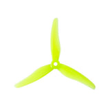 Two pairs of yellow Gemfan Hurricane 51433 3-blade drone propellers for quadcopters, showcasing their lightweight design and aerodynamic shape.