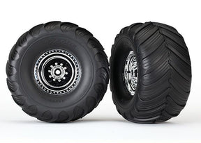 Pair of Traxxas chrome monster truck wheels with Terra Groove tires for off-road RC vehicles, shown with detailed tread pattern.