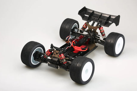 LC Racing EMB-T 1/14 scale 4WD RTR truggy on a dirt track, showcasing its lightweight chassis and rugged off-road tires.