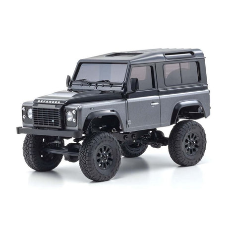 Kyosho Mini-Z MX-01 4x4 Land Rover Defender 90 RC car in gray and black with detailed exterior and off-road tires.