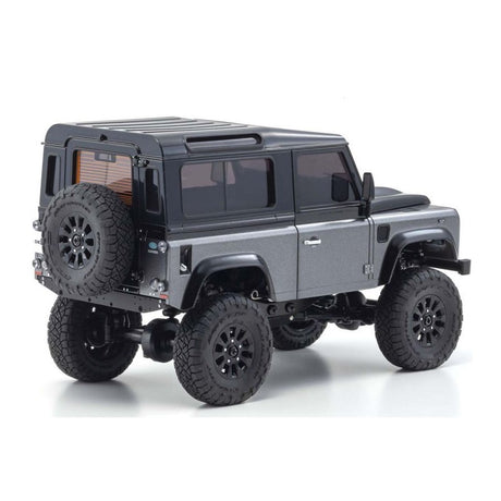Kyosho Mini-Z MX-01 4x4 Land Rover Defender 90 RC car in gray and black with detailed exterior and off-road tires.
