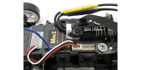 Kyosho Mini-Z RC car aluminum oil damper mount for MR-04, close-up view of lightweight metal component.