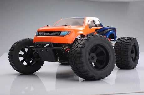 LC Racing EMB-MT 1/14 4WD RC monster truck with pink and black body, large tires, and detailed chassis in action.