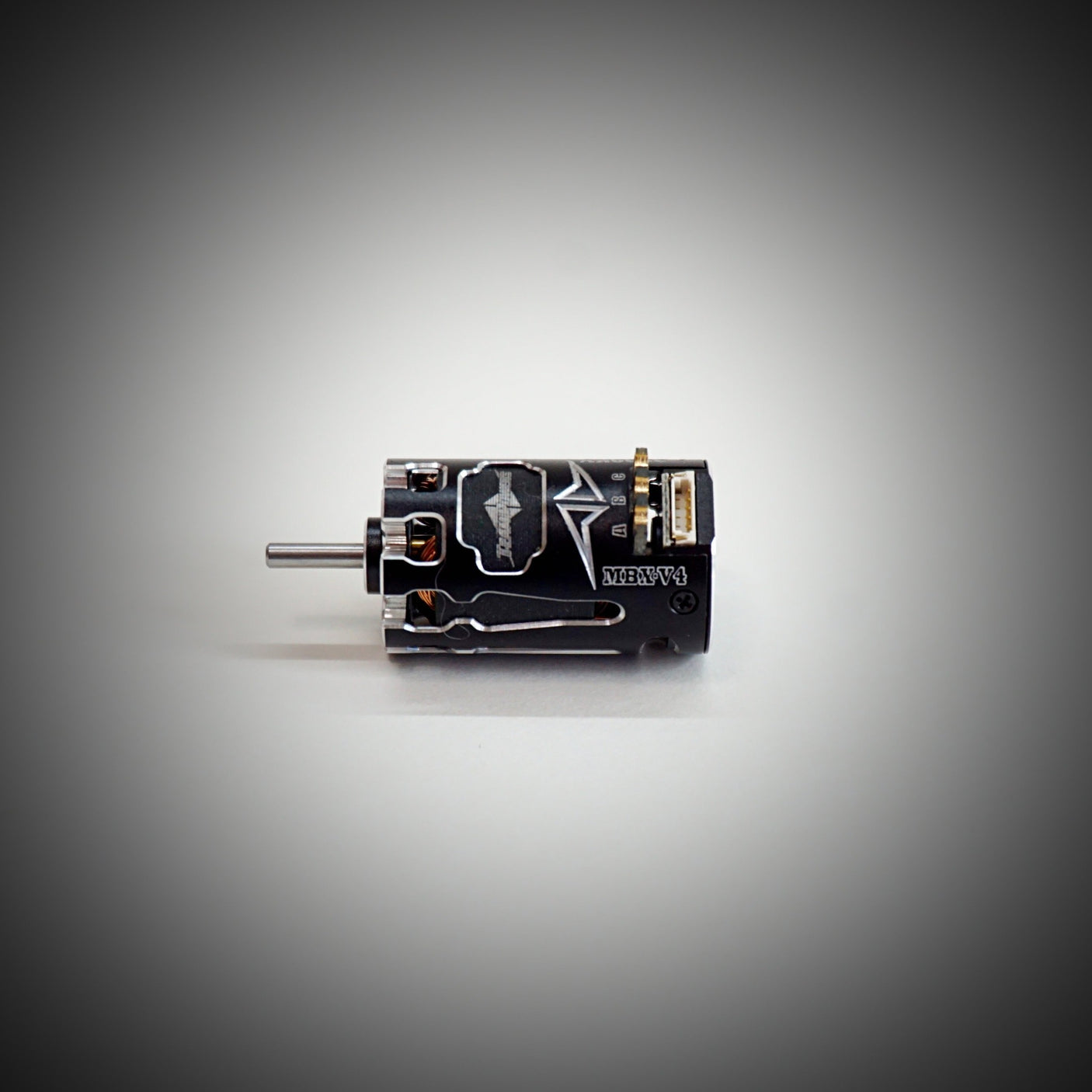 Team Powers MBX V4 Mini-Z RC car with sensored brushless motor, showing the sleek black motor and compact design.