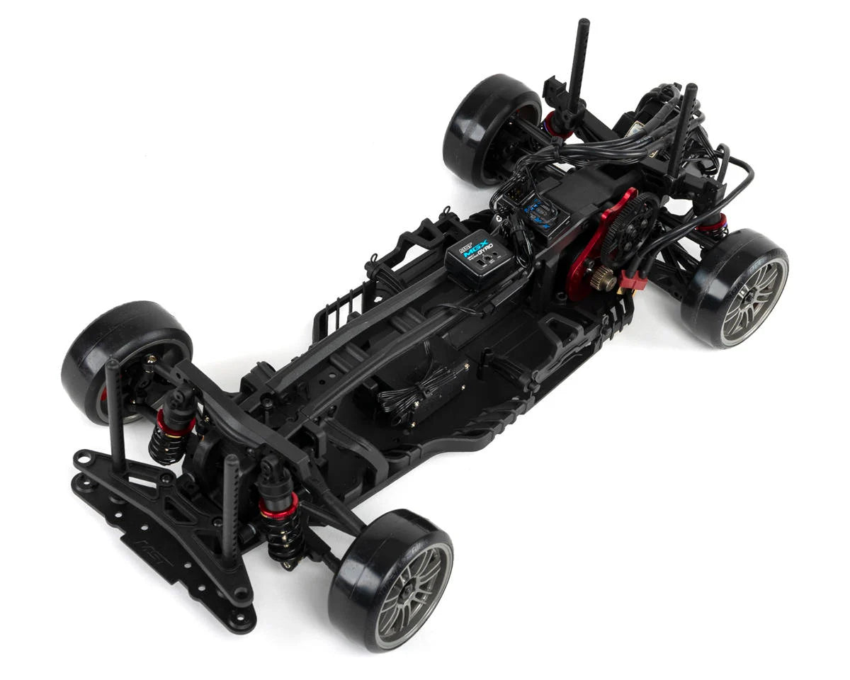 MST RMX 2.5 1/10 scale 2WD brushless drift car with purple A90RB body, showcasing detailed design and racing wheels.