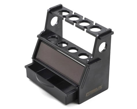 ProTek RC shock stand for 1/10 and 1/8 scale RC cars, black plastic with adjustable supports, used for maintenance and setup.