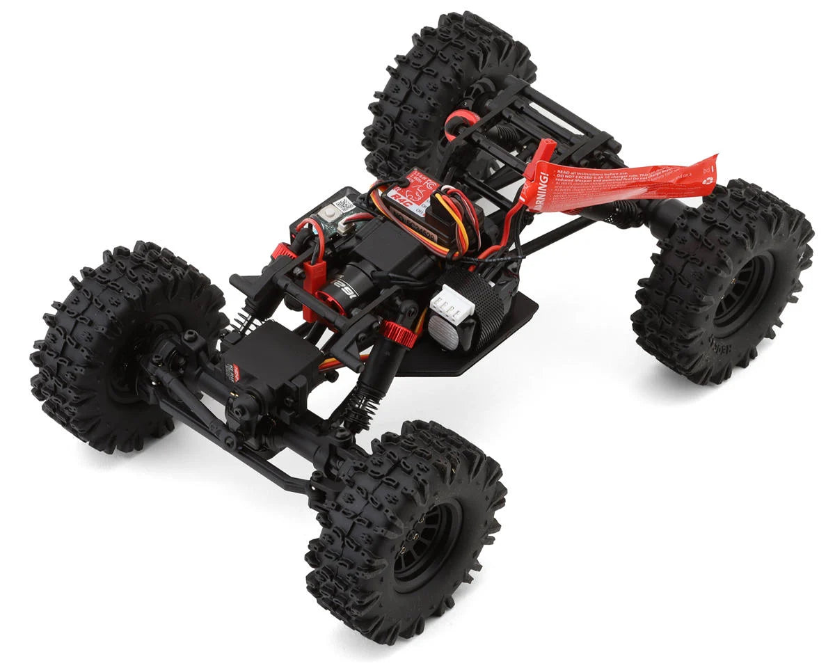 Redcat Ascent-18 Apex 1/18 scale 4WD RTR competition crawler on rugged terrain with detailed chassis and bright red body.