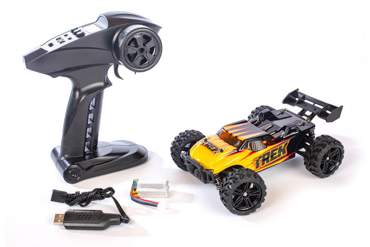 Rage RC Mini Trek 1/24 RTR Truggy off-road RC vehicle on dirt surface with rugged tires and detailed body.
