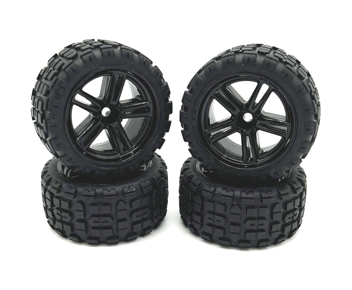 Four Rage RC Mini Trek MT wheels and tires for RC trucks, showing black wheels with rugged tires for off-road driving.