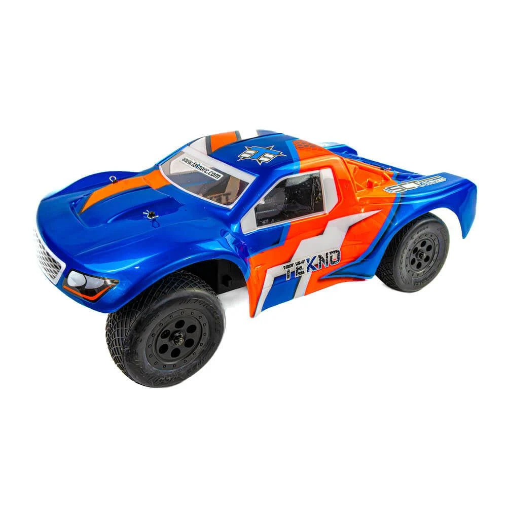 Tekno SCT410 2.0 1/10th scale 4x4 short course truck kit front-left angle with body on, showcasing detailed design and build.