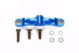 Tamiya TT-02 aluminum steering bridge for RC car, silver metal component with precise machining and mounting points visible.