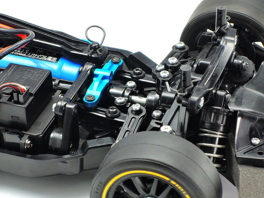 Tamiya TT-02 aluminum steering bridge for remote control car, showing the silver metal component attached to the chassis